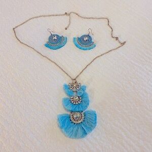Necklace and earrings. Blue, frilly with stones.